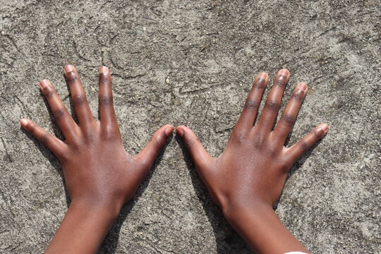 Two Hands  With All Ten Fingers Spread Out Over Grey Concrete Background