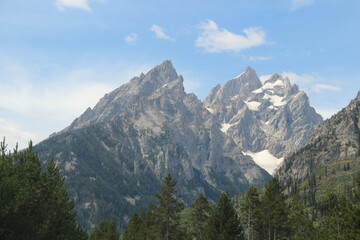 Grand teton in blue skies and some snow on top.