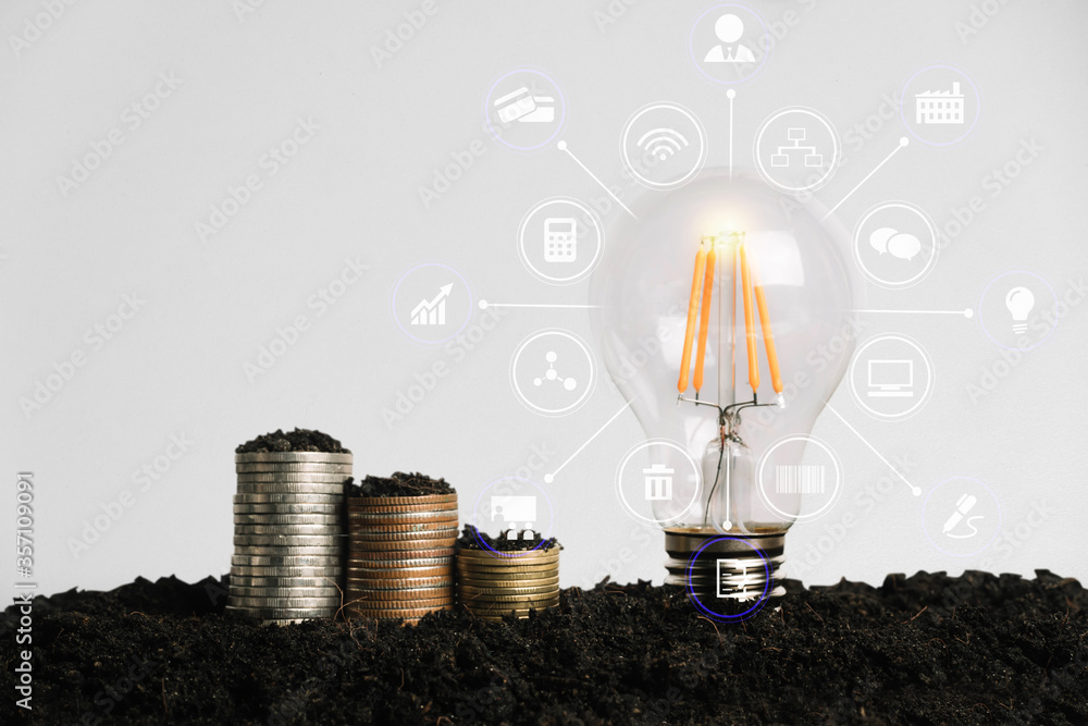 Wall mural Light bulb with heap of coins stairs for financial plan or business idea concept.