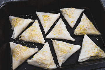 plant-based food, vegan tofu and peas samosas in baking tray before being cooked