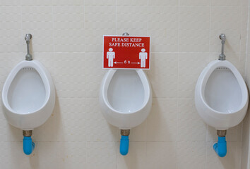 PLEASE KEEP SAFE DISTANCE 6 ft on washroom urinal. New normal that people need to keep social...