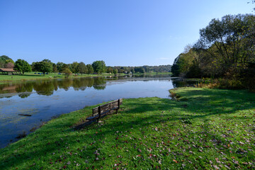 Bench next to lake on a crisp spring day