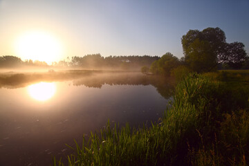 Fototapeta na wymiar morning fog on the river. sunrise over the lake.
