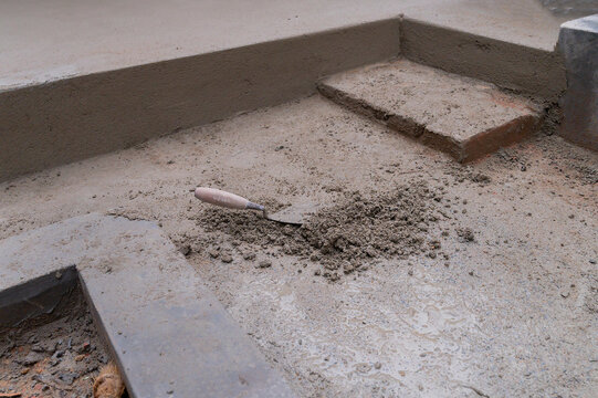 Grounds At Different Heights Are Being Plastered Using Trowel And Cement Manually, Stock Image.