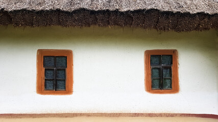 Old window in a vintage traditional peasant house in Ukraine. Antique wooden window frame. Pirogovo...