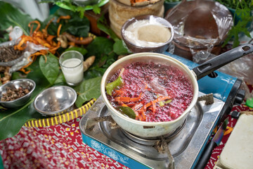 boil traditional herbal medicine wedang uwuh, red-colored boiled water from secang wood shavings