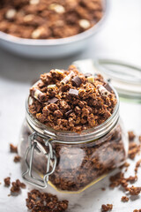 Jar of muesli with dark and milk cocolate pieces - closeup