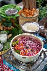 boil traditional herbal medicine wedang uwuh, red-colored boiled water from secang wood shavings