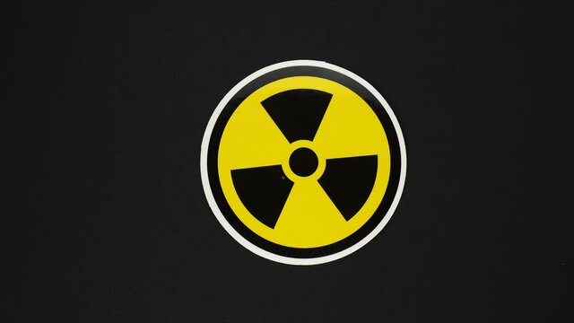 Nuclear Sign Symbol rotate around isolated on black background. Radiation Symbol