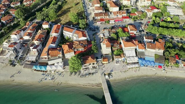 Aerial drone footage of beautiful small mediterranean village by the sea. village Siviri in West Kassandra, Halkidiki peninsula, Greece