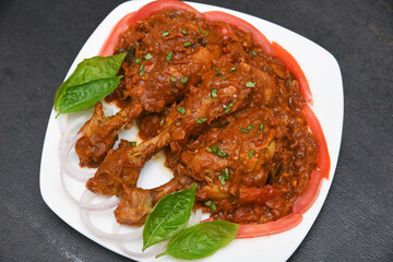 Top view Butter chicken or Murgh Makhani curry roast or Vindaloo hot and spicy gravy dish in Dhaba Punjab, India. North Indian non-vegetarian cuisine Garam Masala. Malabar Chicken curry tikka massala.