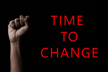 Concept against racism or racial discrimination by showing with hand gestures fist with Time to change typography