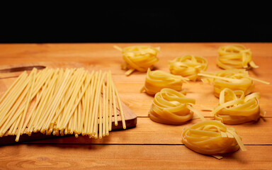 Raw uncooked pasta on the rustic wooden table