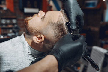 Man with a beard. Hairdresser with a client.