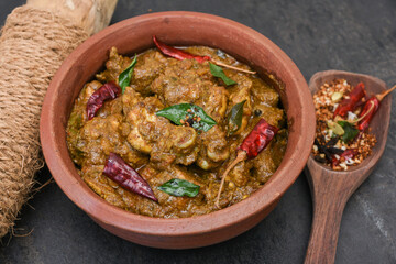 Chettinad chicken curry is a hot and spicy dish Tamil Nadu, South India. Gravy prepared from roast and ground Indian spices,coconut or garam masala for meat / non-vegetarian recipe/ cuisine.