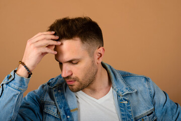 Obraz premium Handsome man standing and smiling isolated on light brown studio background. Male half-length portrait. The human emotions, facial expression concept. Front view.