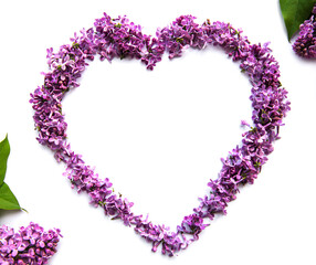 Frame of branches and flowers of lilac in the shape of a heart