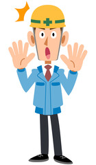 驚くヘルメットを被った作業着の男性
