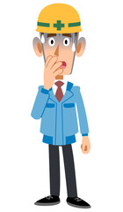 青ざめるヘルメットを被った青い作業着の男性
