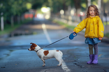 little girl with a dog jack russell terrier / child childhood friendship, pet, small dog in the autumn park walk