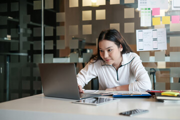 Young asian designer woman drawing a website outline and website ux app development on mobile phone.