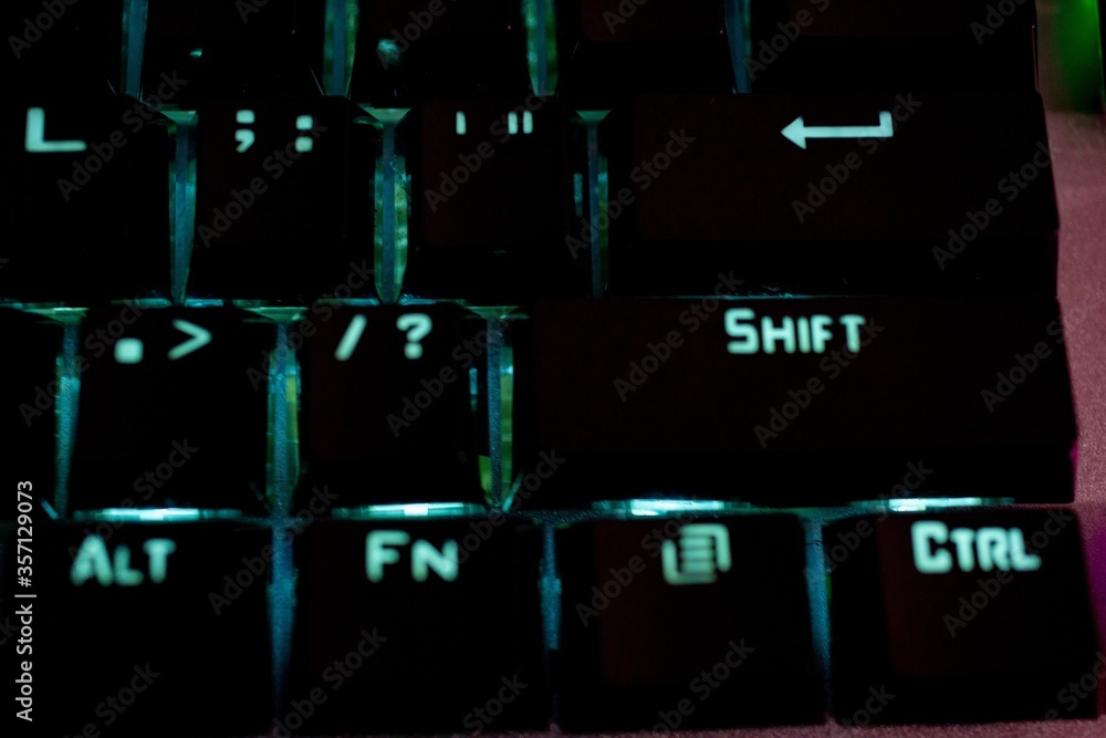 Poster closeup shot of an illuminated computer keyboard