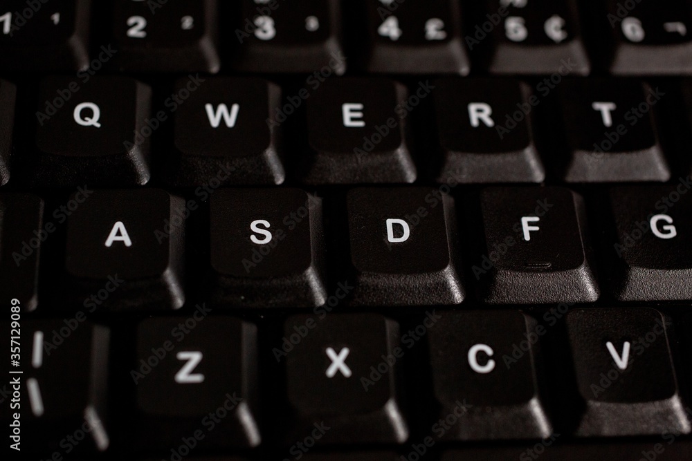 Poster closeup shot of black computer keyboard buttons