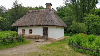 Fototapeta na wymiar The old house of peasants in the museum Pirogovo. National Museum of Folk Architecture and Everyday Life of Traditional Folklore Houses of Different Regions of Ukraine