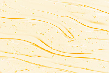 Oil serum texture. Yellow vitamin C, vitamin E liquid gel. Transparent cosmetic cream with bubbles...