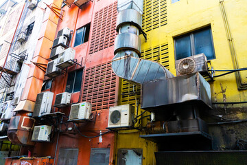 Naklejka premium Homes in Asia hung with air conditioning. Hot climate. Narrow streets. The spirit of Asia.