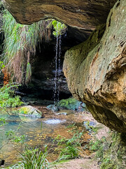 rock pool with a flowing waterfall