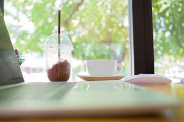 notebook was placed on a table by the window for doing business online at home during the outbreak of the Covid outbreak.