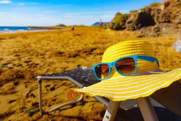 Summer hat and sunglasses on beach