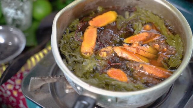 ginger, lemongrass, lime leaf and shaved wood shavings boiled in a pan, the raw material of jamu empon-empon