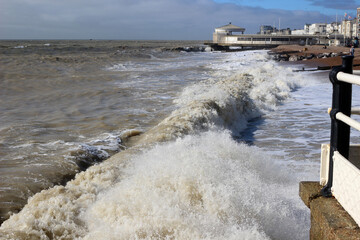 Strong waves crashing below the pier at Worthing, England.