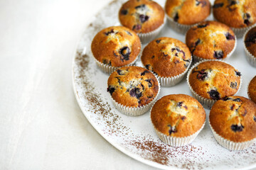 Plate with freshly baked sweet muffins. Sweet pastries, recipes, cooking