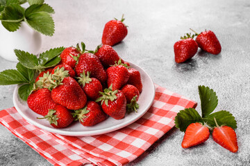Beautiful juicy fresh strawberries on the concrete surface of the table