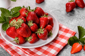 Beautiful juicy fresh strawberries on the concrete surface of the table