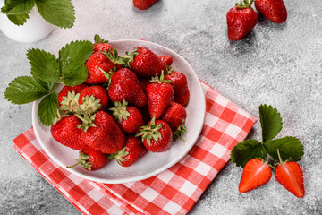 Beautiful juicy fresh strawberries on the concrete surface of the table