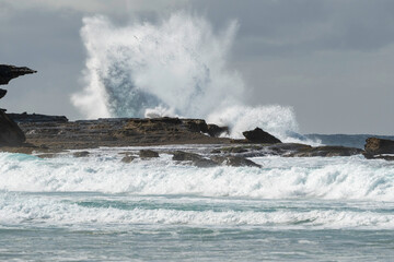 Fototapeta premium Huge waves smashing against the cliffs at Maroubra Beach/ waves crashing on rocks 