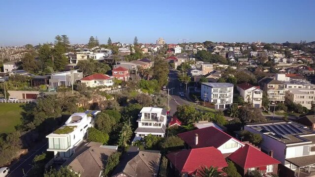 Aerial view of residential houses at spring. Establishing shot of Australian neighborhood, suburb. Real estate, drone shots, sunset, sunlight, push in from above.
