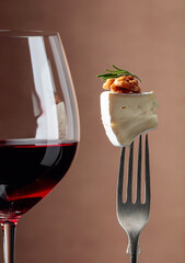 Red wine and cheese with walnut.