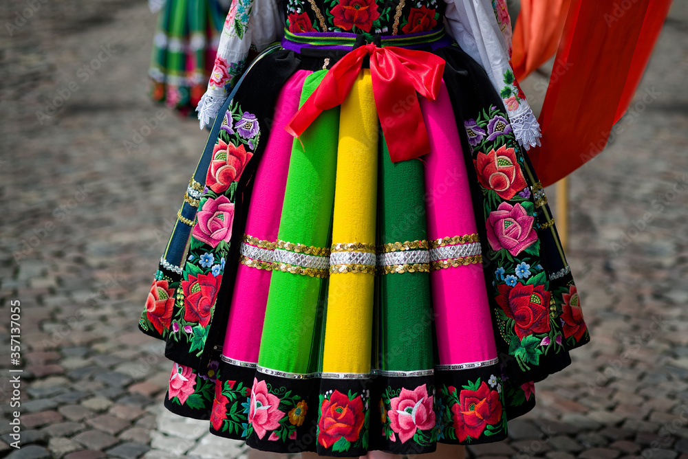 Wall mural Women and young girls wearing regional folk costumes from Lowicz region in Poland during annual Corpus Christi procession