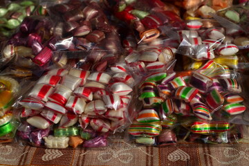 Fototapeta na wymiar Assorted colorful candies on the table at the candy shop