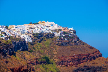 Traditional white cave houses on a cliff on the island Santorini, Cyclades, Greece