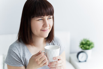 happy woman drinking coffee at home