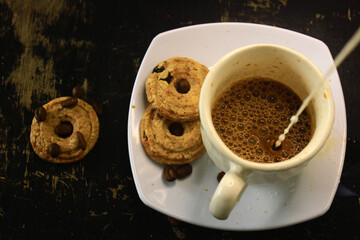 the process of making flat white coffee by pouring steam milk into a cup of espresso, served with...