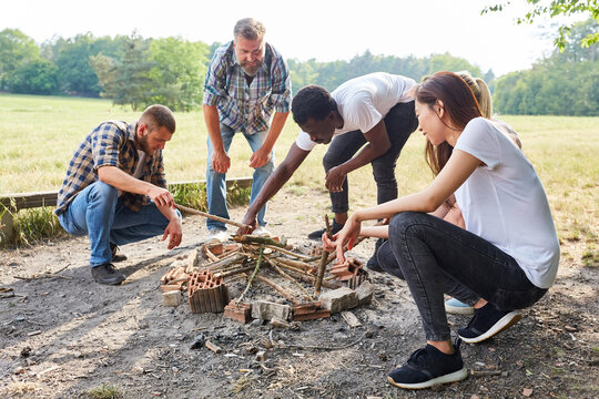 Group of young people collects firewood together