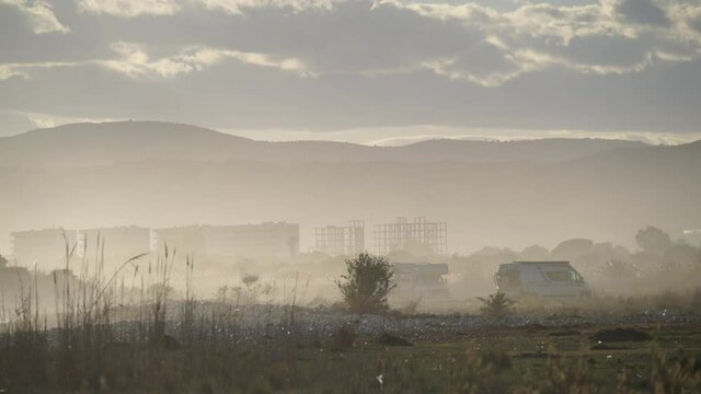 Caravan, recreational vehicle camping on seaside meadow field at overcast day. Capi Corb location, Valencia, Mediterranean coast of Spain. Traveling by motorhome