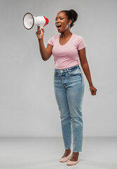 communication, feminism and human rights concept - african american young woman speaking to megaphone over grey background